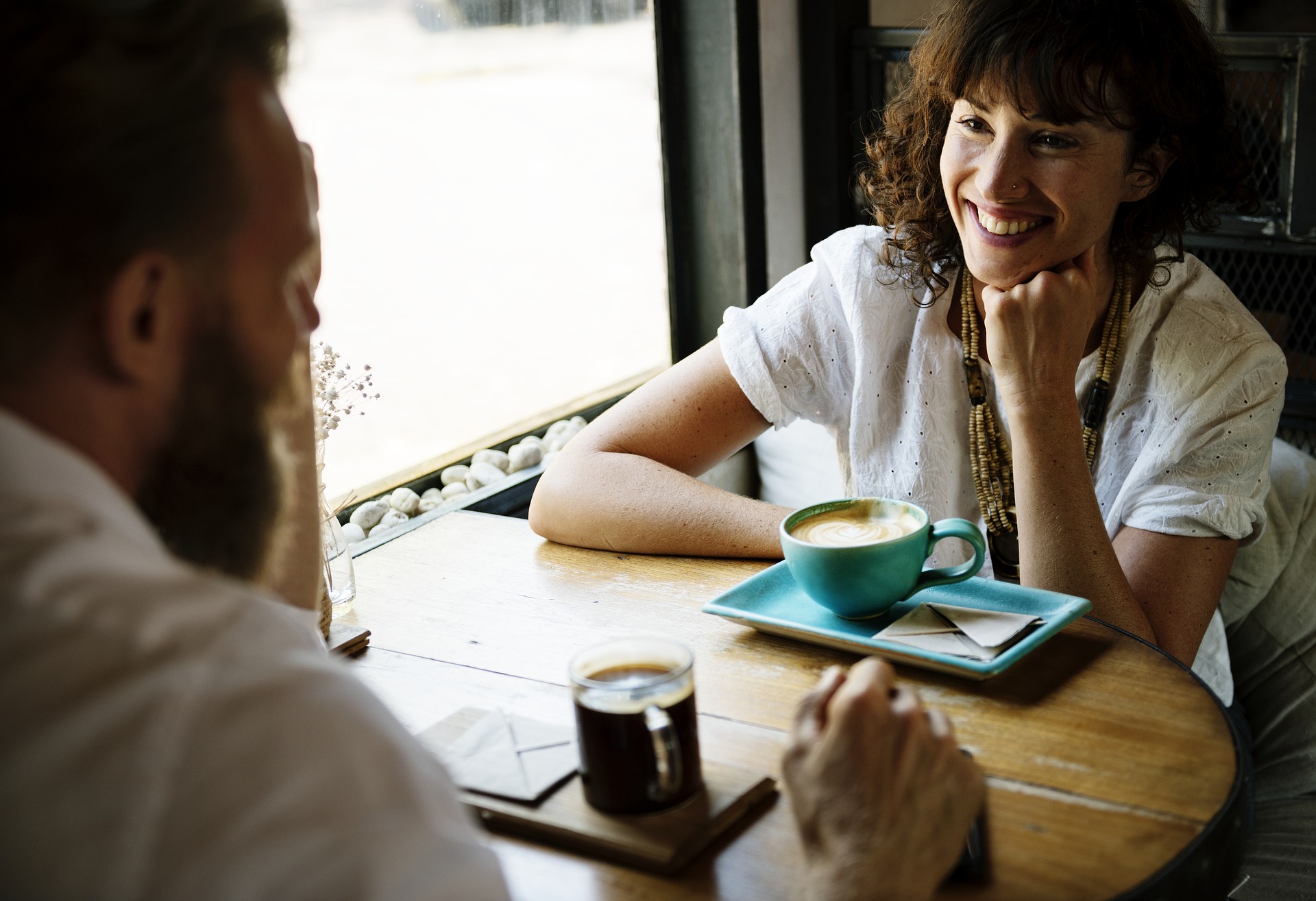 Man and woman talking over a cup of coffee